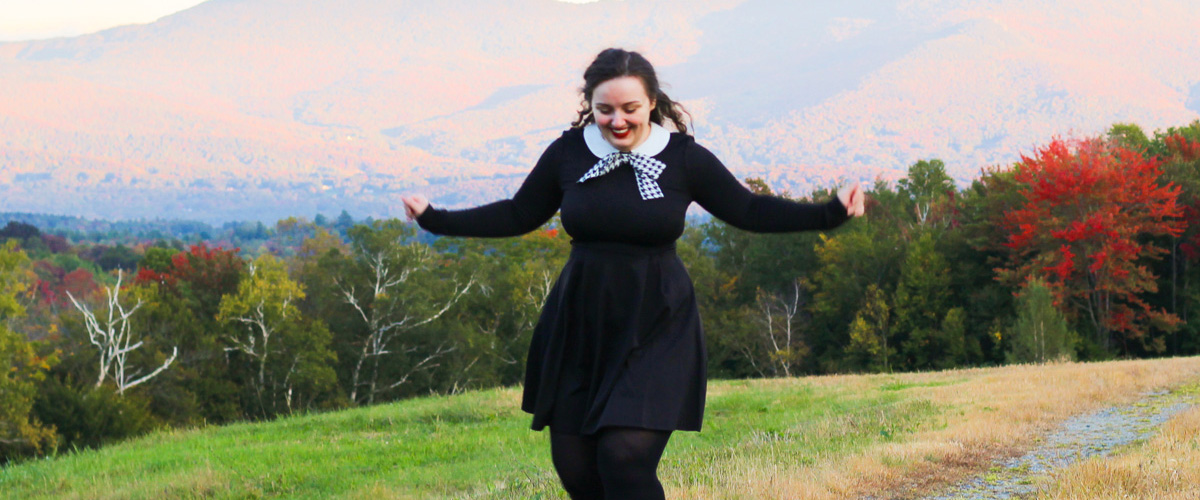 Guest Blogger, Joanna No Banana, walking in grassy field with trees and mountains in the background