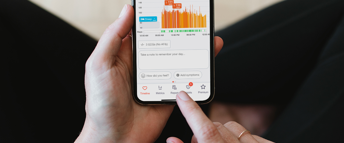 Someone touching their phone, looking at the Cardiogram app