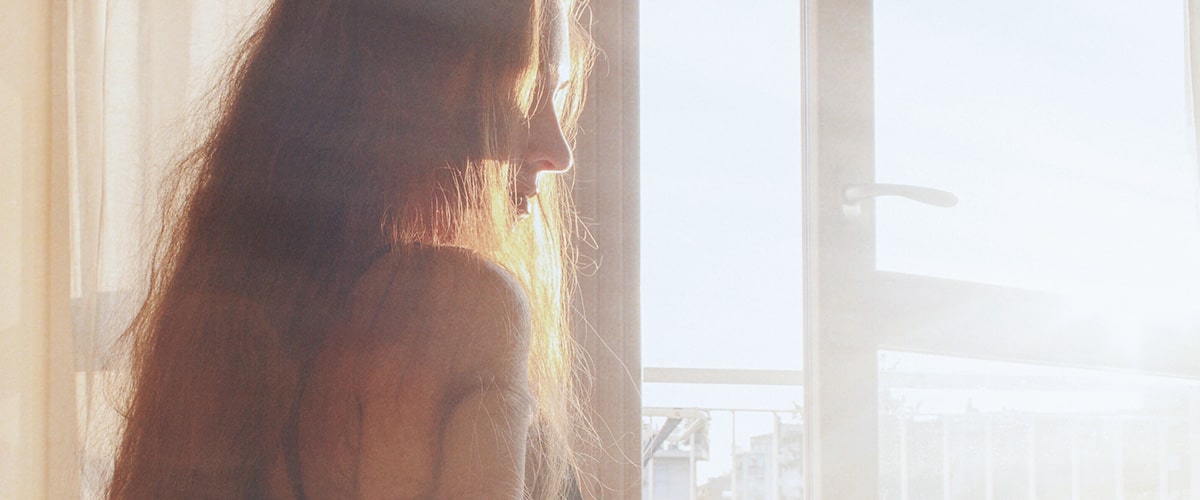 Women standing in front of window with sunlight coming in