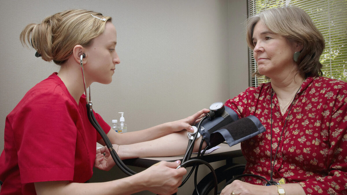 a nurse getting a blood pressure to an old lady